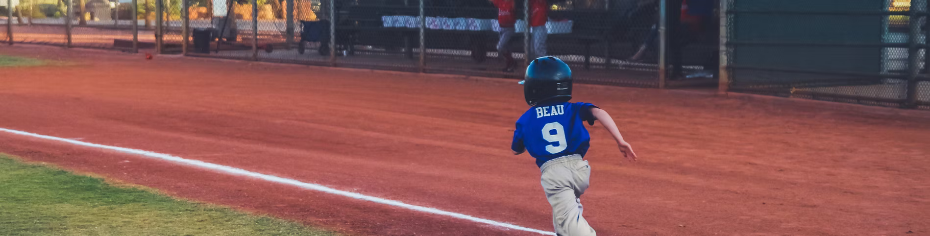 Youth baseball player running bases